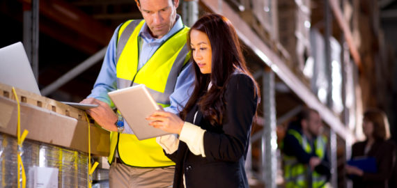 warehouse manager checks something with her supervisor